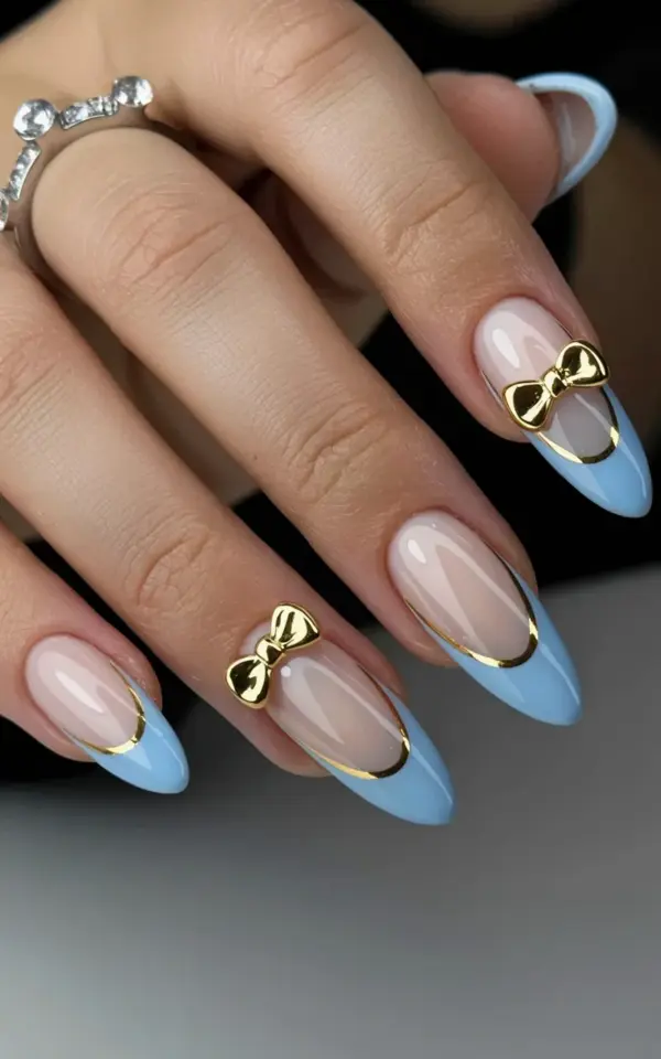 Stiletto Acrylic Nails with Blue French Tips and Gold Bows