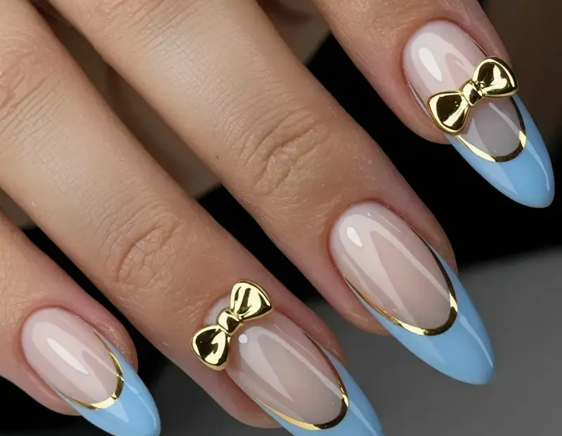 Stiletto Acrylic Nails with Blue French Tips and Gold Bows